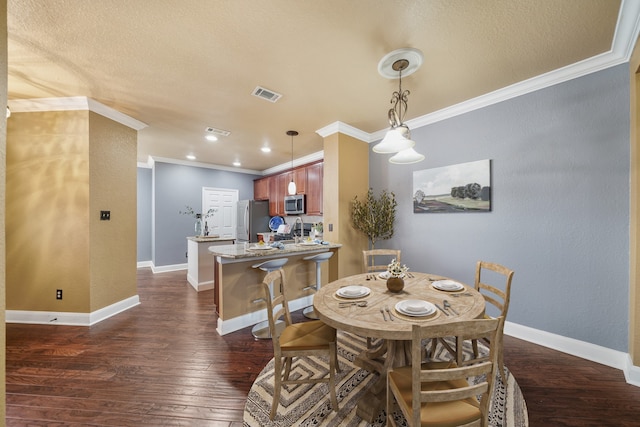 dining space with ornamental molding, a textured ceiling, and dark wood-type flooring