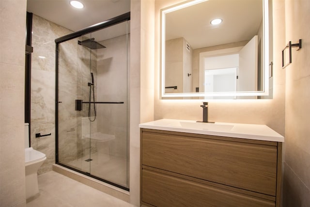 bathroom featuring vanity, tile patterned floors, toilet, and an enclosed shower