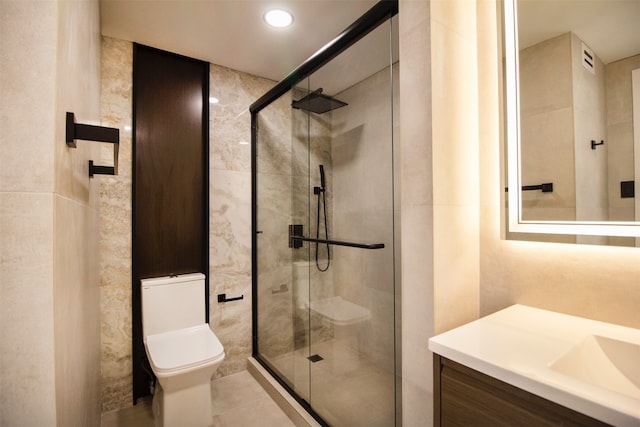 bathroom featuring vanity, tile patterned floors, toilet, and an enclosed shower