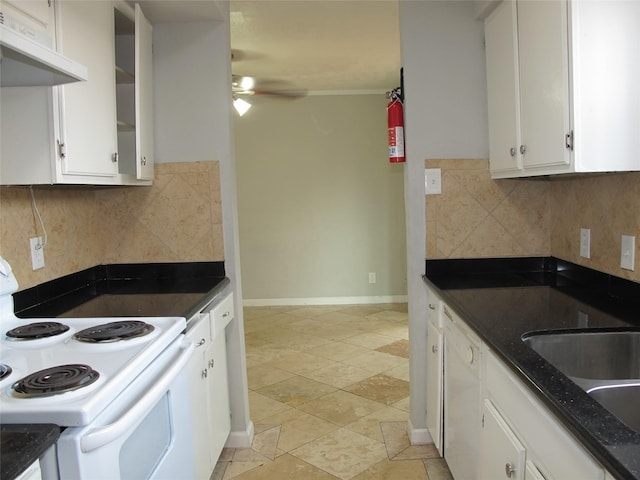 kitchen with dark stone counters, backsplash, white appliances, and white cabinetry