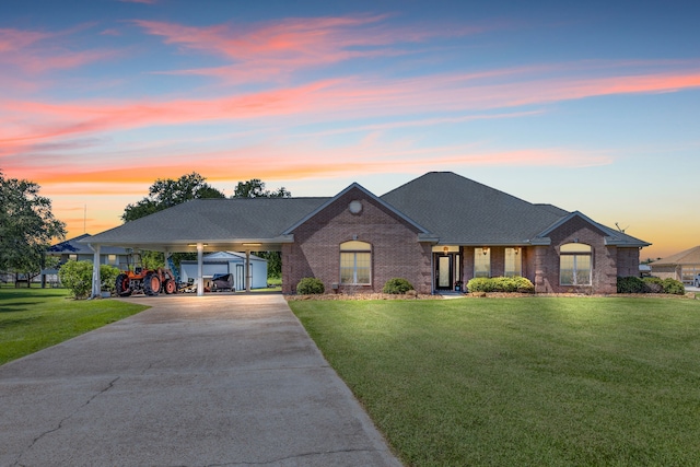 view of front of house with a lawn and a carport