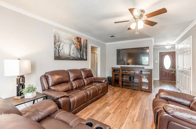 living room featuring light hardwood / wood-style flooring, ornamental molding, and ceiling fan