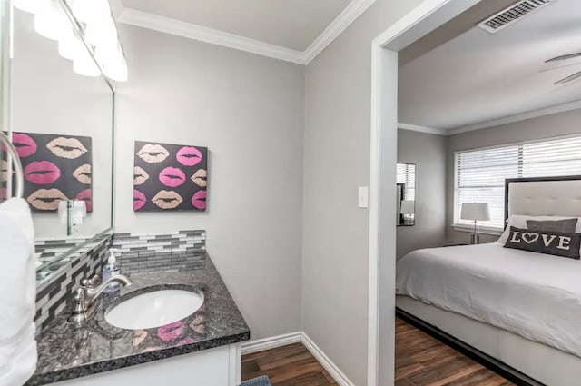 bathroom with vanity, crown molding, and wood-type flooring