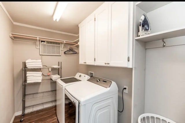 laundry area featuring cabinets, an AC wall unit, dark wood-type flooring, washing machine and dryer, and crown molding