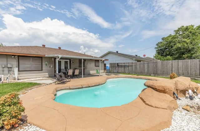 view of pool featuring fence, a fenced in pool, french doors, and a patio