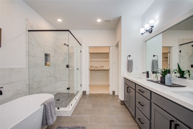 bathroom with vanity, plus walk in shower, and tile patterned flooring