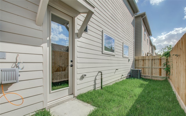 view of property exterior featuring a yard and central AC unit