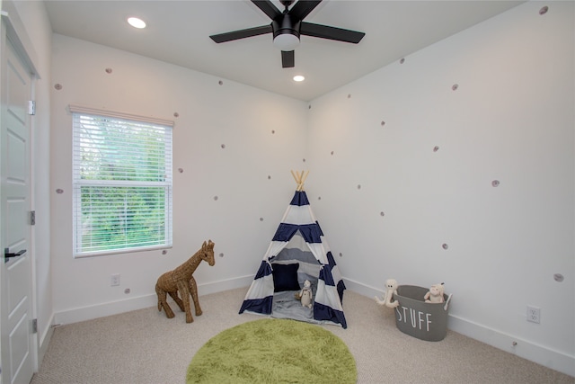 game room featuring ceiling fan and light colored carpet