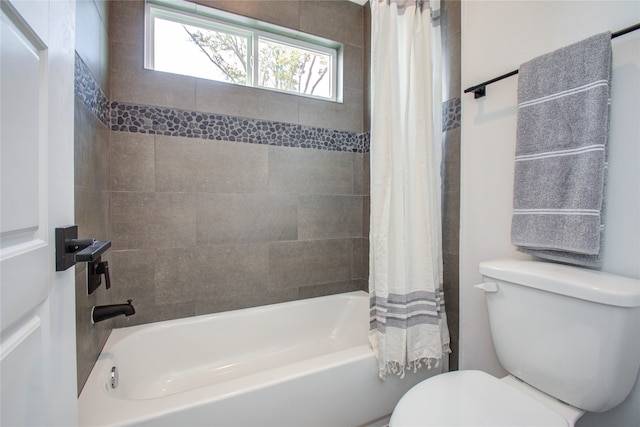 bathroom with shower / tub combo with curtain and toilet