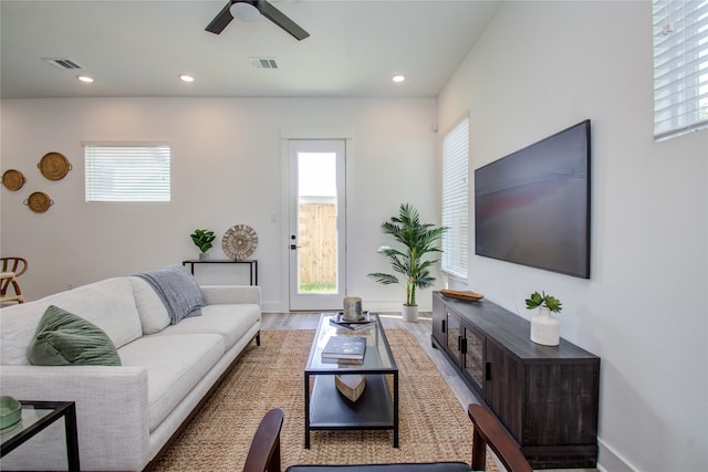 living room featuring ceiling fan and light hardwood / wood-style flooring