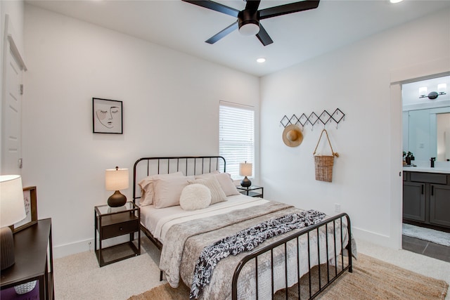 carpeted bedroom featuring connected bathroom and ceiling fan