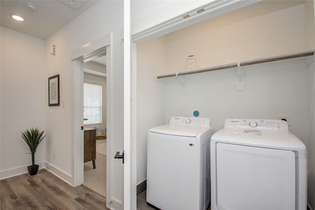 clothes washing area featuring dark wood-type flooring and separate washer and dryer