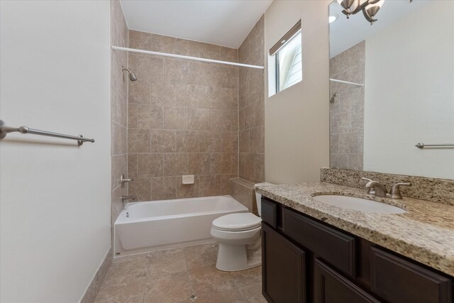 full bathroom with vanity, toilet, and tiled shower / bath