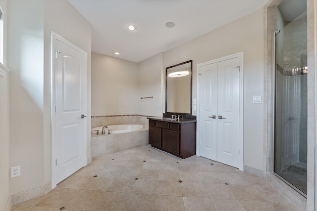 bathroom featuring vanity, tile patterned flooring, and plus walk in shower