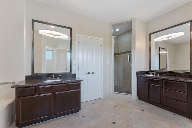 bathroom with tile patterned floors, vanity, and an enclosed shower