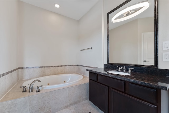 bathroom featuring vanity, tile patterned flooring, and a relaxing tiled tub