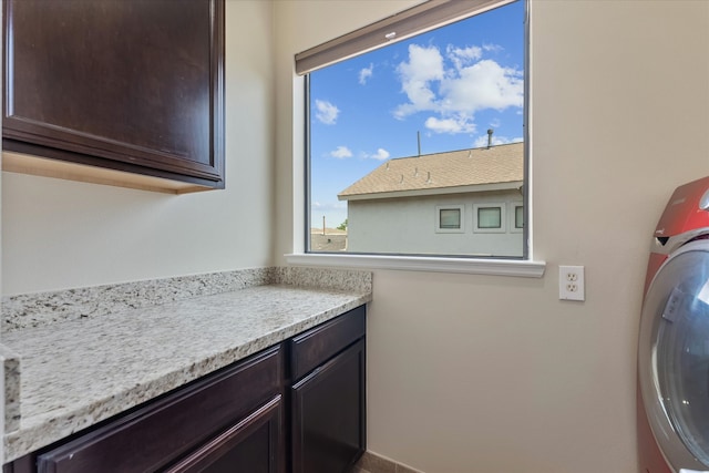 laundry room featuring cabinets and washer / dryer