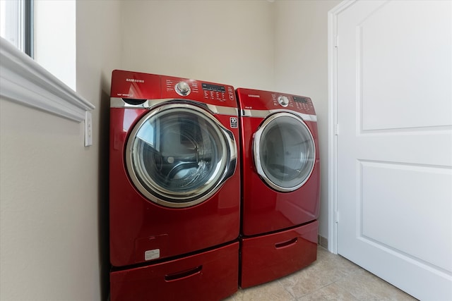 laundry room with washing machine and dryer and light tile patterned flooring