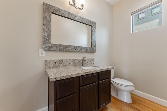 bathroom featuring hardwood / wood-style flooring, vanity, and toilet