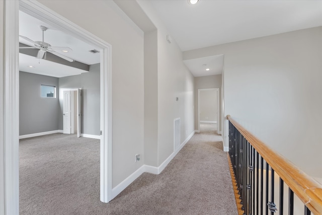 hallway featuring light carpet