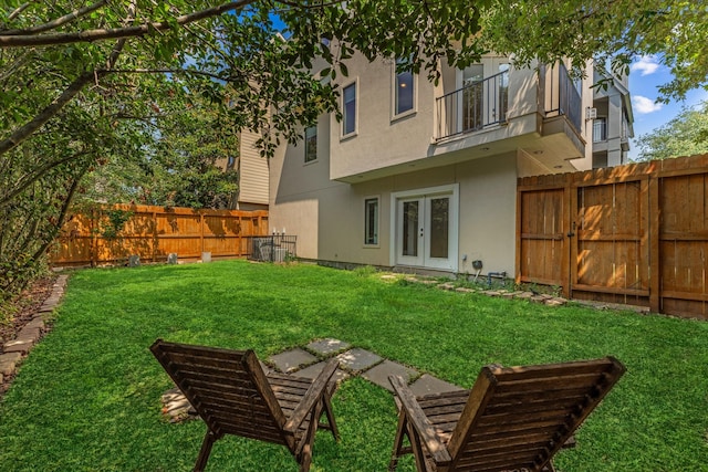 rear view of property with a yard and french doors