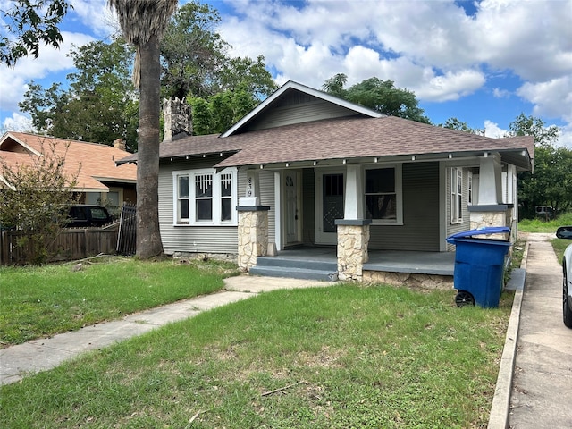 view of front facade featuring a front lawn and covered porch