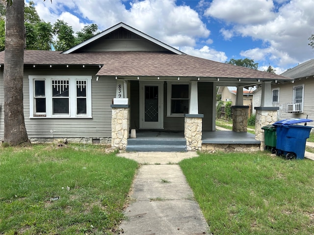 view of front of home featuring a front yard and a porch