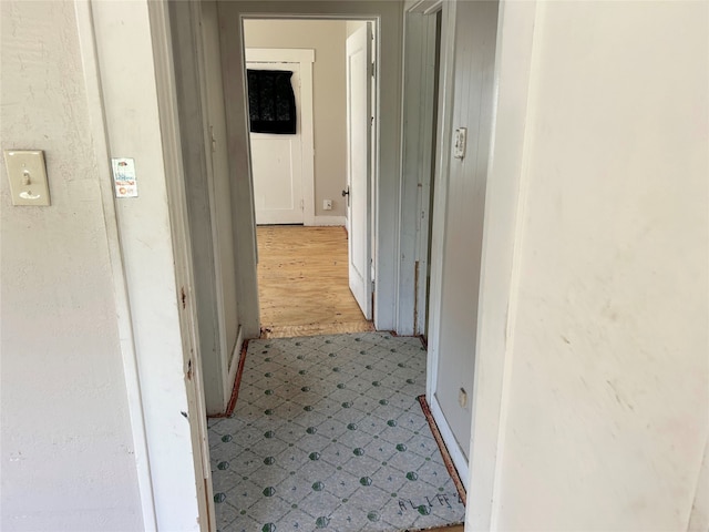 hallway with light hardwood / wood-style flooring