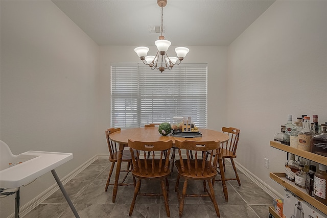 dining area featuring a notable chandelier