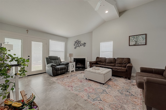 living room featuring ceiling fan, french doors, vaulted ceiling, and a healthy amount of sunlight