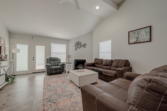 tiled living room with vaulted ceiling, ceiling fan, and french doors