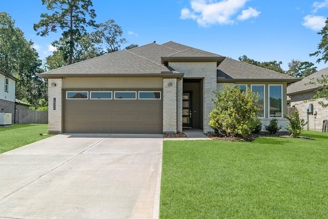 view of front of property featuring a front lawn and a garage