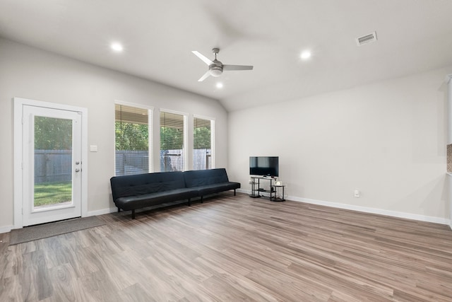 unfurnished living room featuring light wood-type flooring, lofted ceiling, and ceiling fan