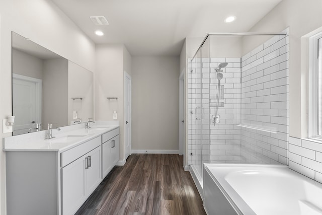 bathroom with shower with separate bathtub, vanity, and hardwood / wood-style floors