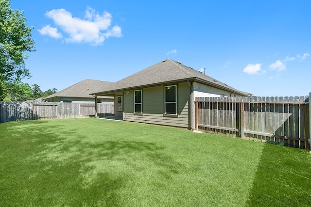 rear view of house with a patio and a yard