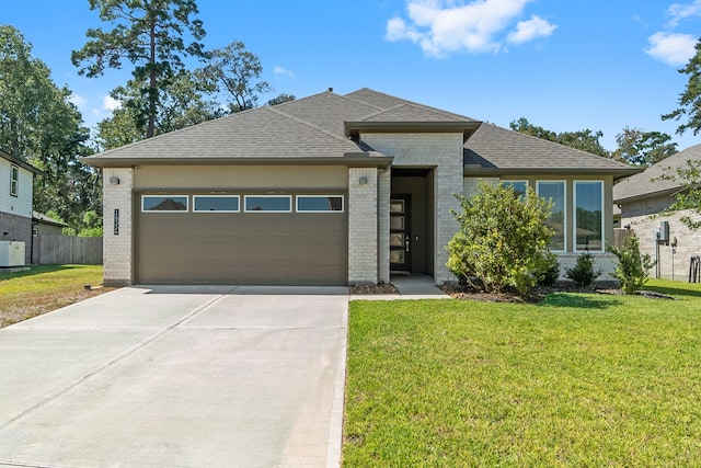 view of front facade with a front yard and a garage