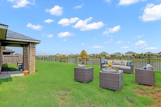 view of yard with outdoor lounge area and a water view