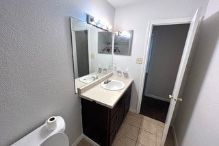 bathroom featuring tile patterned floors, vanity, and toilet