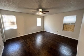 unfurnished room featuring ceiling fan, a textured ceiling, and dark wood-type flooring