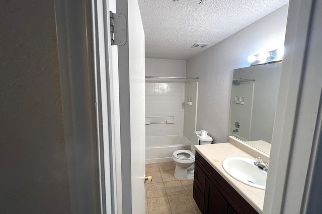 full bathroom with vanity, tiled shower / bath combo, tile patterned flooring, a textured ceiling, and toilet