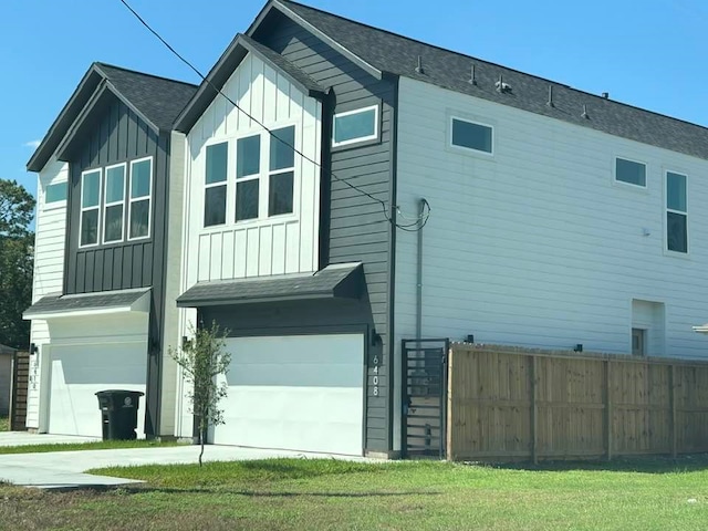 view of side of home with a yard and a garage