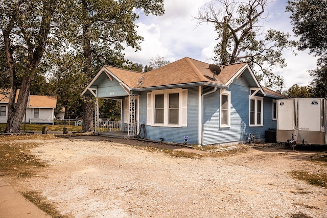 view of front of home featuring covered porch and roof with shingles