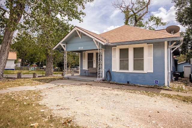 bungalow-style home featuring covered porch and an outdoor structure