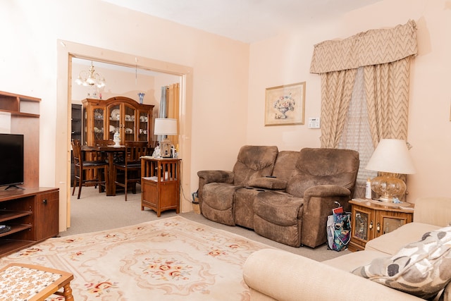 carpeted living room featuring a notable chandelier