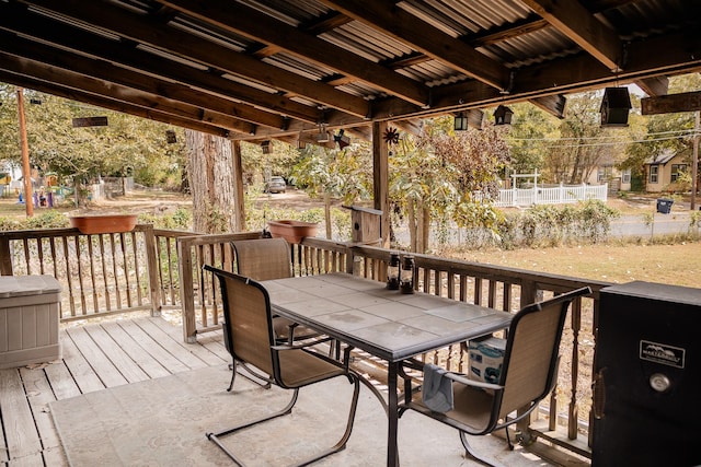 wooden terrace featuring outdoor dining area