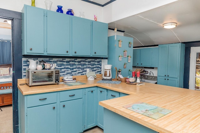 kitchen with blue cabinets, a toaster, and tasteful backsplash