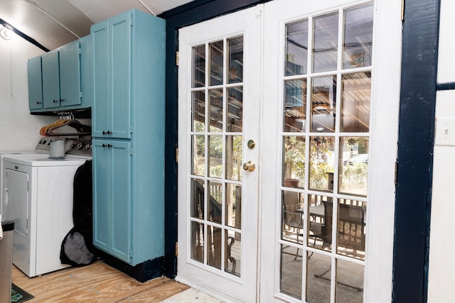 washroom featuring light hardwood / wood-style flooring, cabinets, and separate washer and dryer