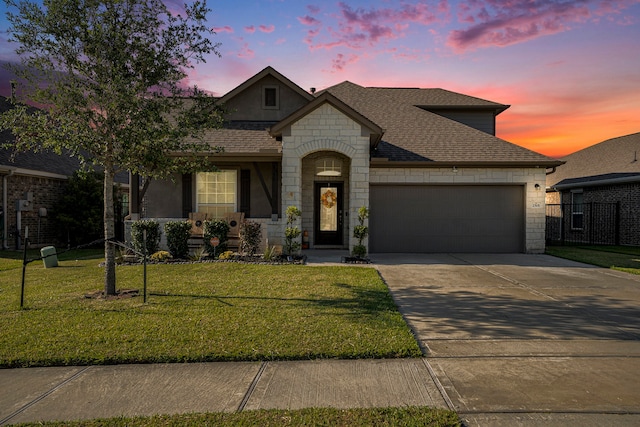 view of front of property with a lawn and a garage