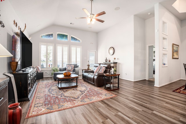 living room with hardwood / wood-style flooring, ceiling fan, and lofted ceiling