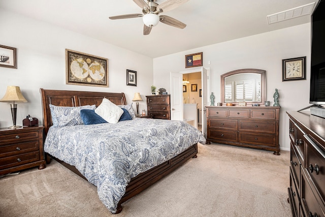 carpeted bedroom with connected bathroom and ceiling fan